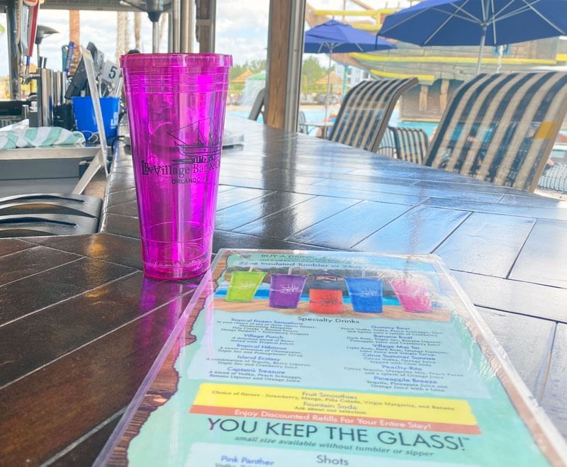 Drink served on countertop with menu in LBV Village Bar & Grill at Lake Buena Vista Resort Village & Spa