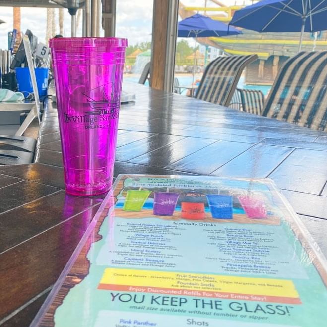 Drink served on countertop with menu in LBV Village Bar & Grill at Lake Buena Vista Resort Village & Spa
