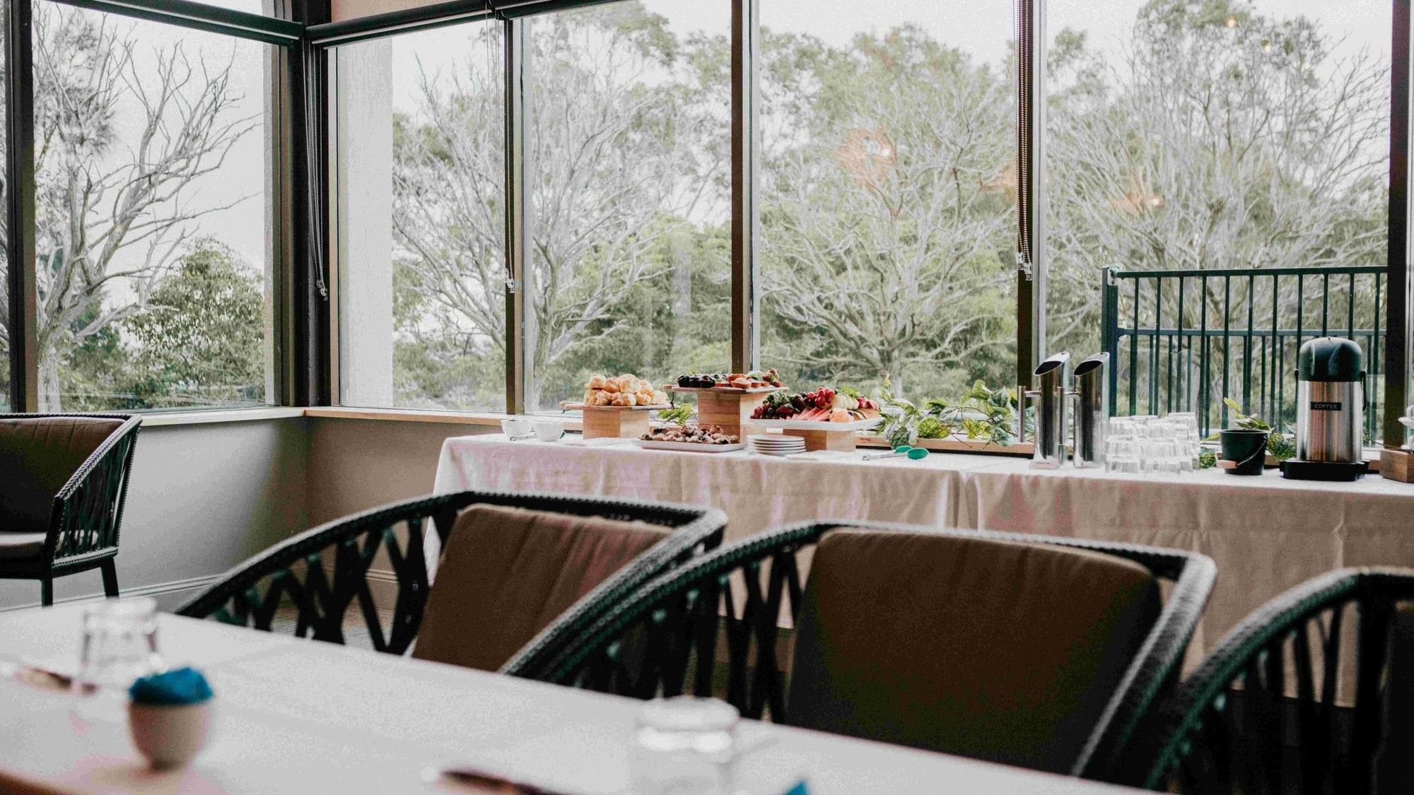 Mercure Charlestown room with large windows and a table set for dining.