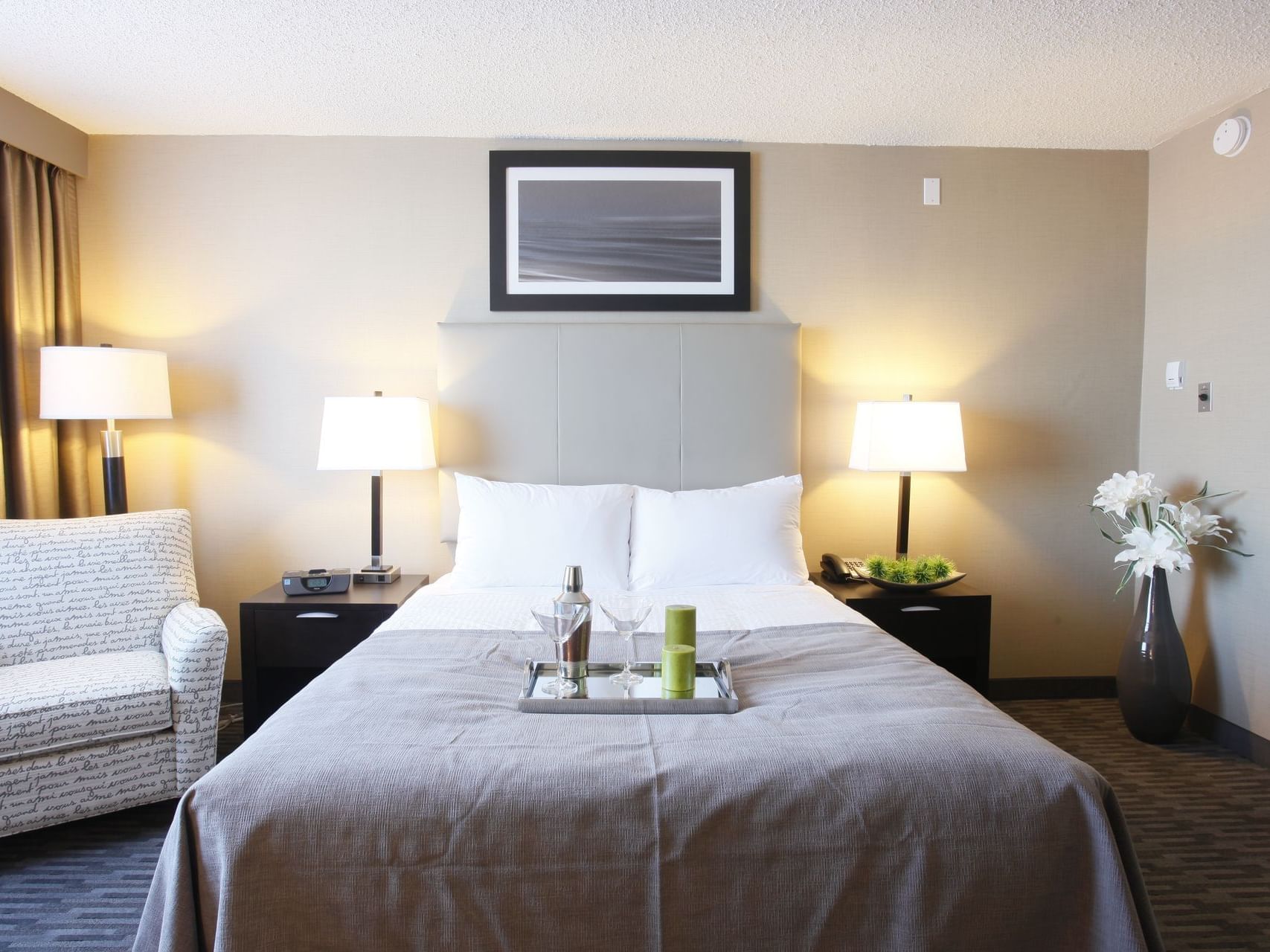 a tray of mixed drinks on a hotel bed