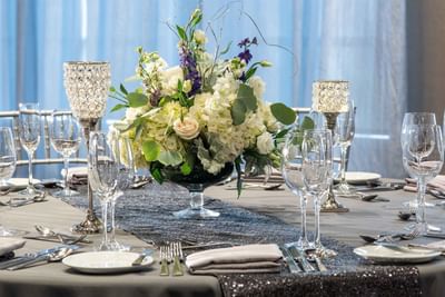 elegantly set table with white flower centerpiece