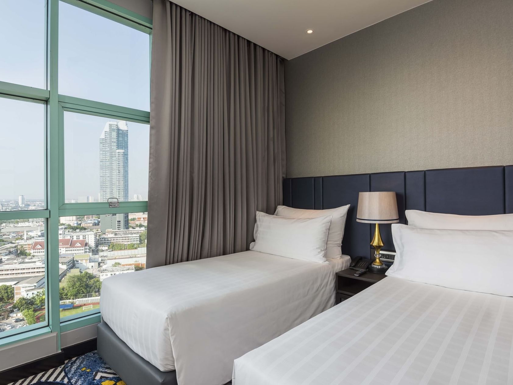Twin beds in Two-Bedroom Suite City View at Chatrium Hotel