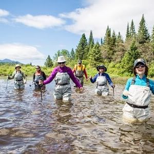 Group of hikers in a river at Adirondack near High Peaks Resort