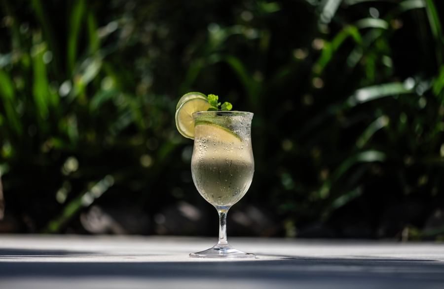 Wine glass of a chilled drink with lime and mint at Tokatoka Resort - Fiji International Airport.