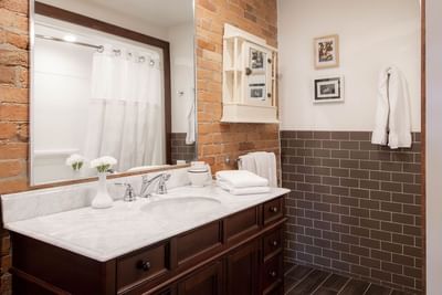 Bathroom with vanity, flower vase, towels & mirror in Executive Residences at Retro Suites Hotel