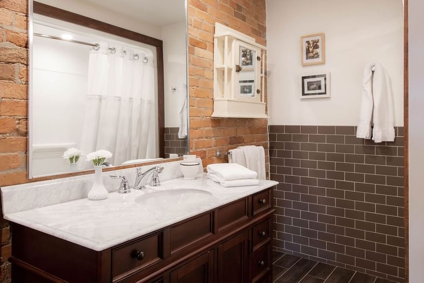 Bathroom with vanity, flower vase, towels & mirror in Executive Residences at Retro Suites Hotel