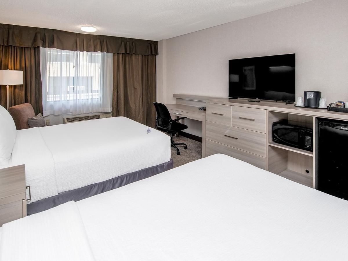 Coast Premium Two Queens room with two queen beds, work desk, TV, and mini-fridge at Coast Calgary University Area Hotel by APA