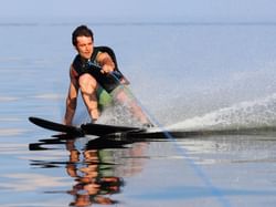 A man water skiing in the sea near ICONA Hotel Windrift