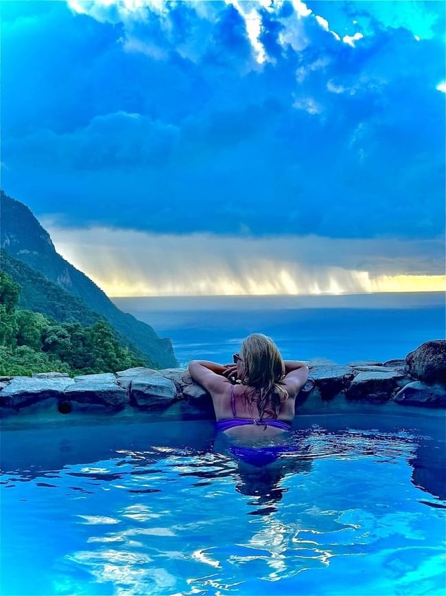 women in a private pool at a luxurious caribbean resort overlooking the serene ocean
