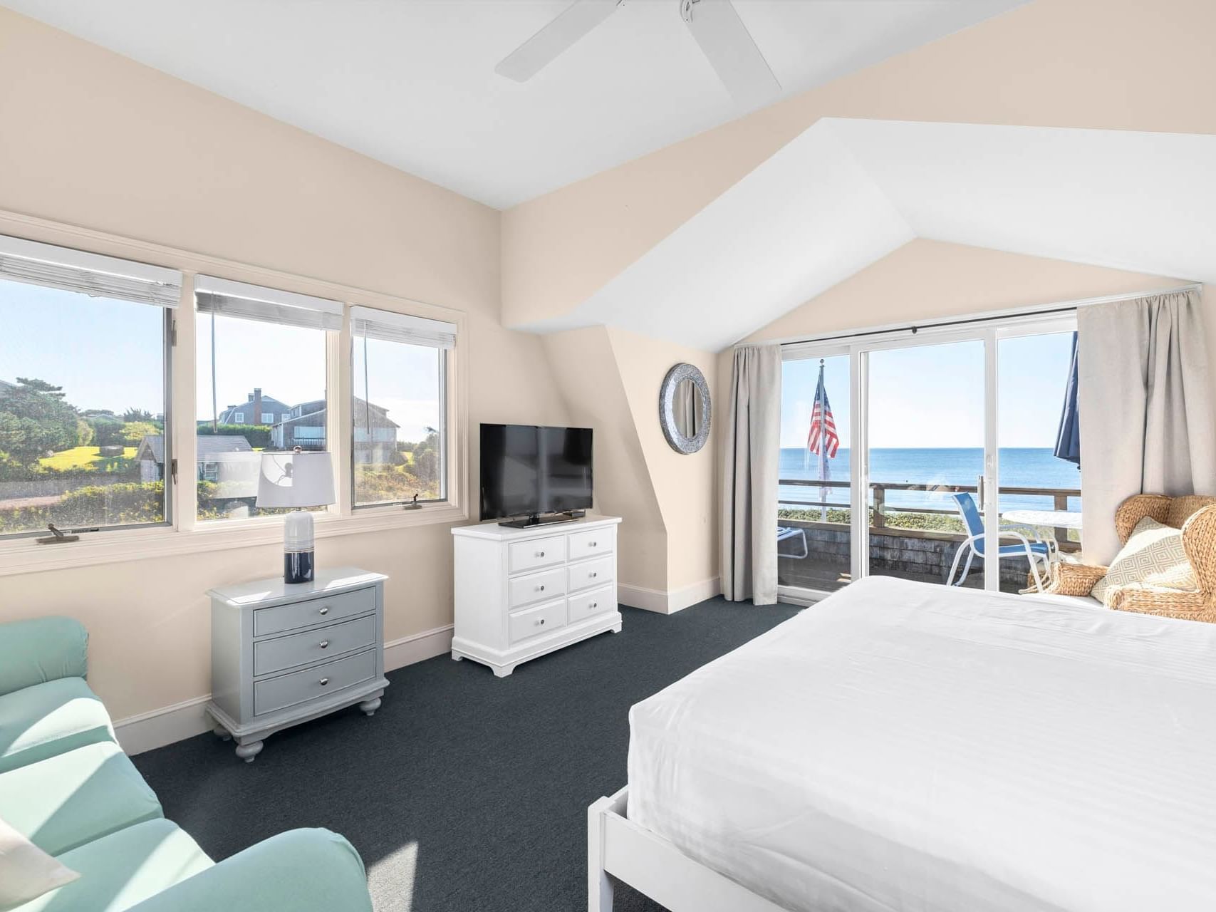 Bed and desks by the sofa with a TV in Suntide Oceanfront Studio at Chatham Tides Resort