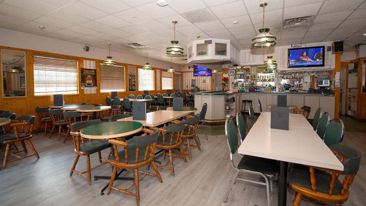 dining area with tables, chairs and televisions at Green Gables Restaurant & Lounge