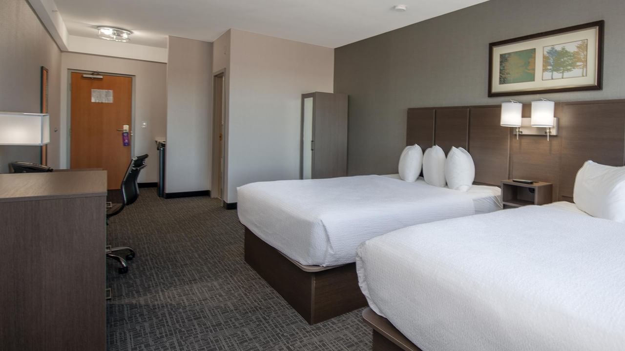 Two beds, nightstands, and a work table.