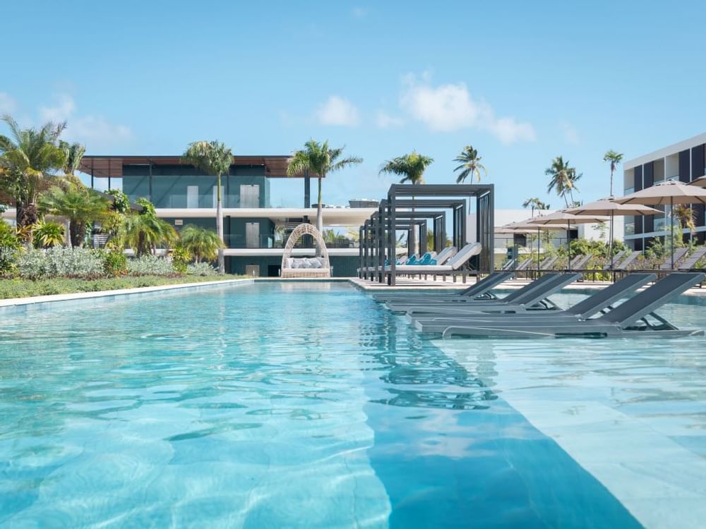 Outdoor swimming area with Pool beds at Live Aqua Resorts