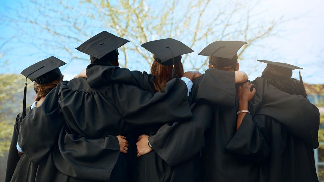 graduates in black gowns and tassels at a nearby university graduation to el PRADO Hotel
