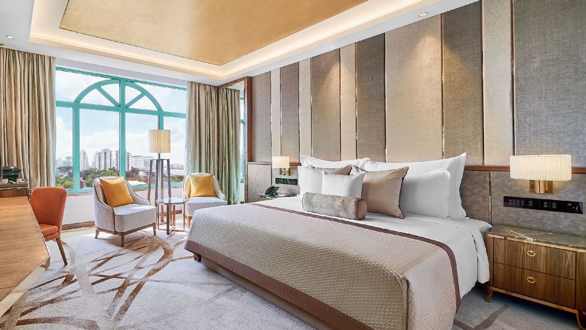 King-size bed with sitting area in Junior Suite at Sunway Velocity Hotel