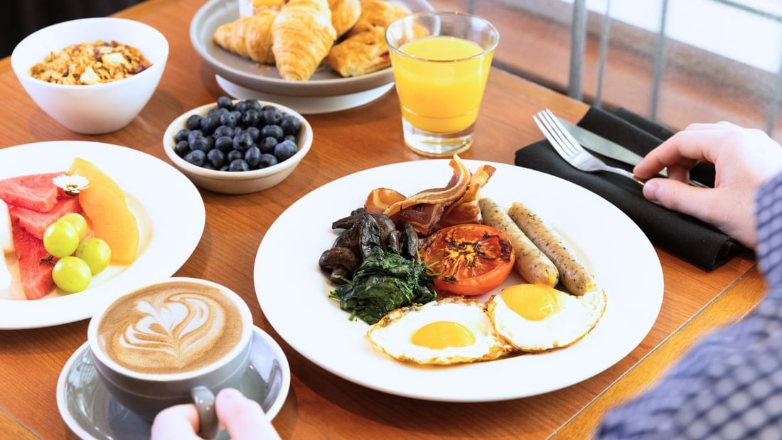 Full English buffet breakfast with fruit platter, orange juice and a barista coffee