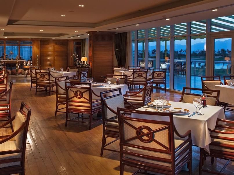 Vintage Bistro with cushioned chairs, dining tables & large windows at Pickalbatros Golf Beach Resort, bars in Sharm El Sheikh