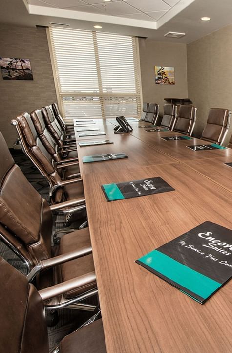 Boardroom table arrangement in a meeting room at Encore Suites Grande Prairie