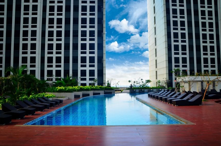 Outdoor swimming pool by the hotel buildings at LK Cikarang Hotel & Residences