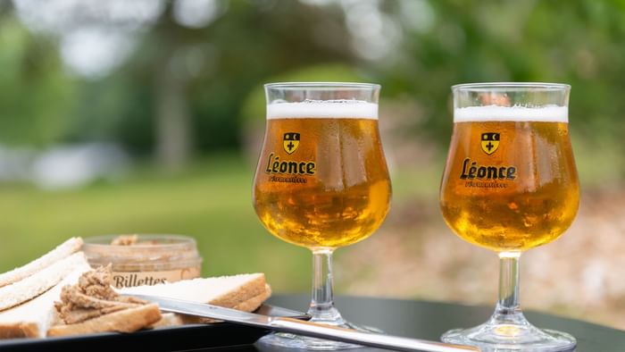 Two beer glasses on a table at Ara Hotel