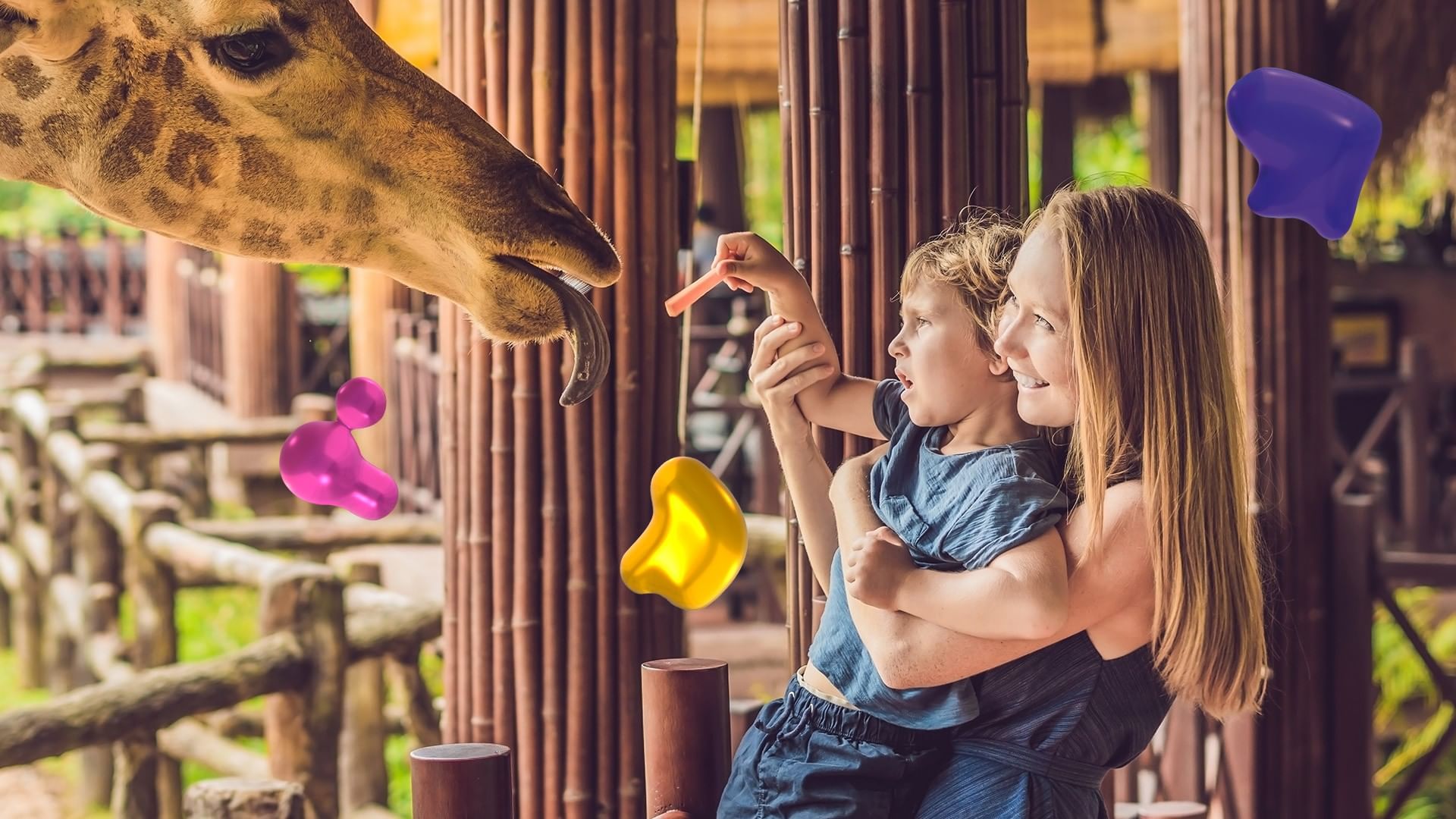 Woman holding a child by a giraffe under a wooden structure at an attraction near the Real Inn Mexicali