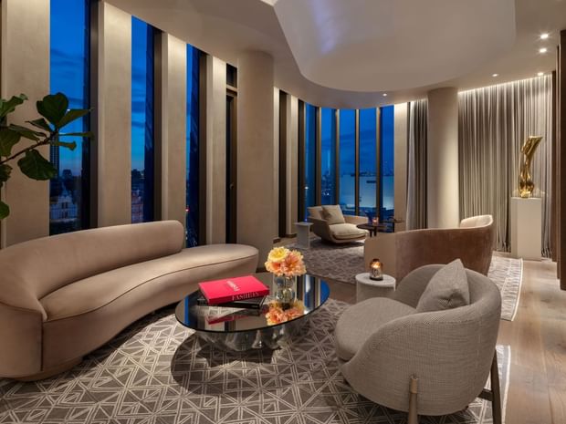 Lounge area with plush seating by the large windows in Tower Penthouse Suite lounge at The Londoner Hotel