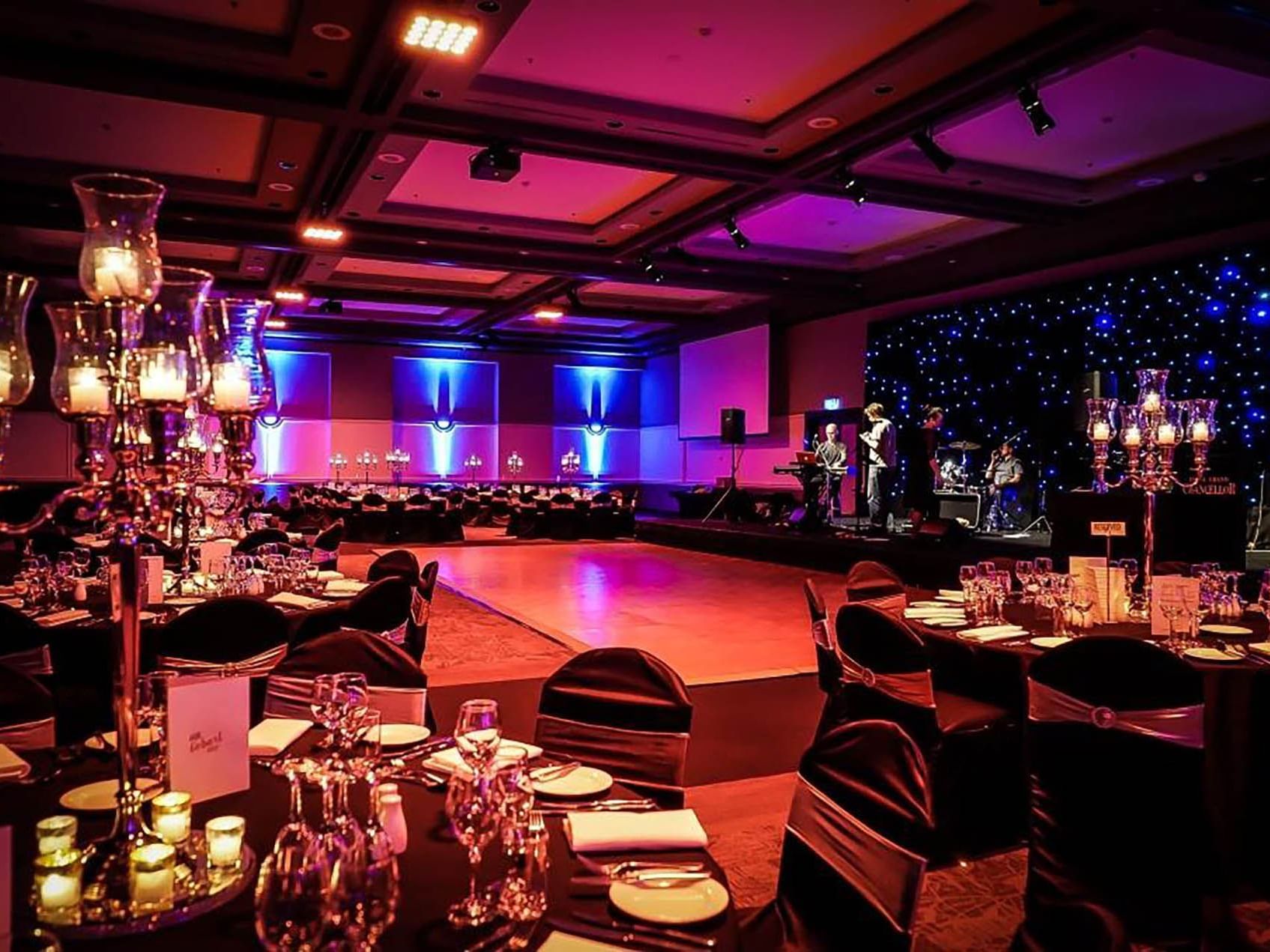 Banquet tables and dancing floor with a band in the background in Grand Ballroom at Hotel Grand Chancellor Hobart