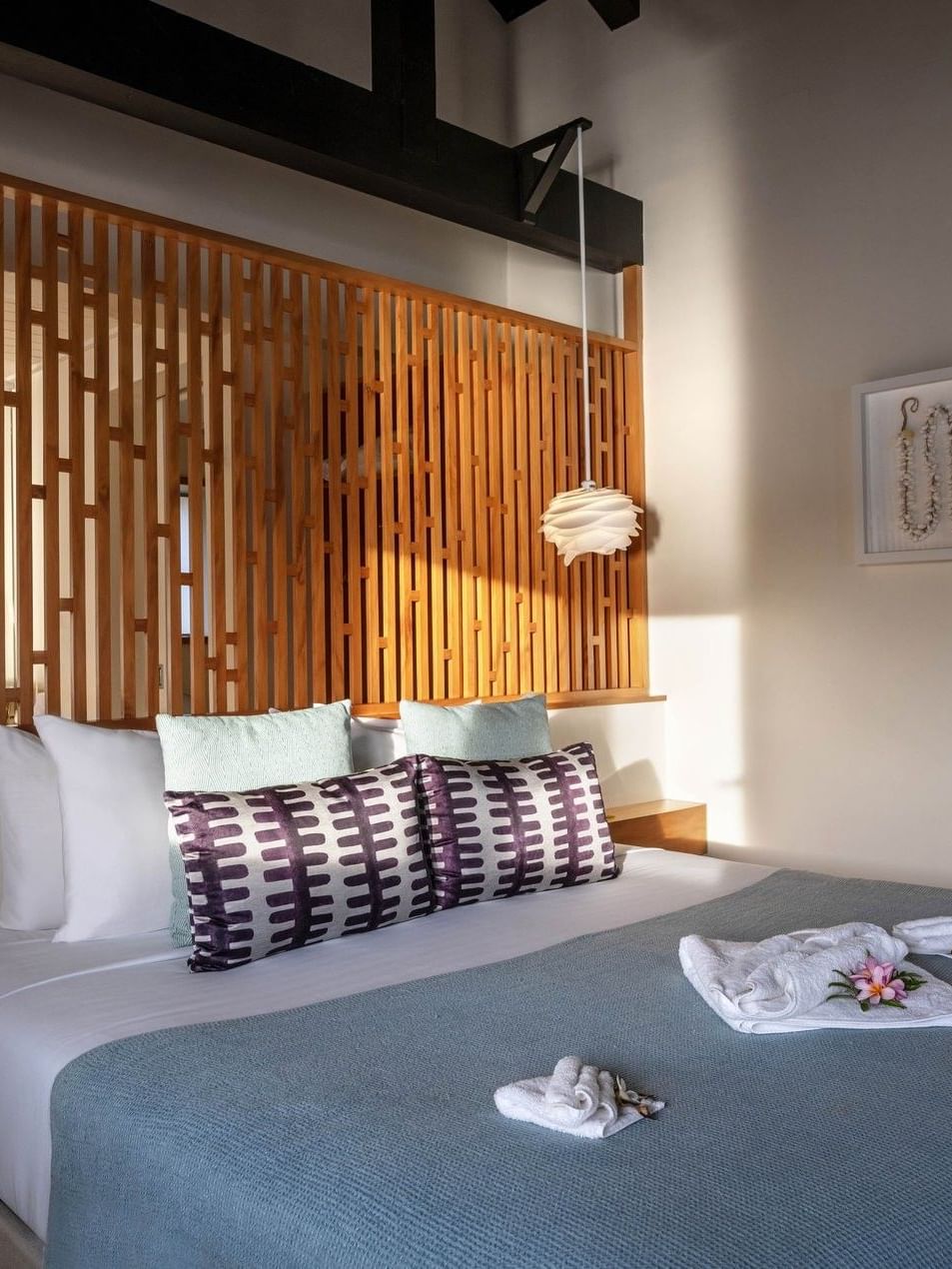 White towels are neatly arranged on the bed in Overwater Villa at warwick le lagon-vanuatu