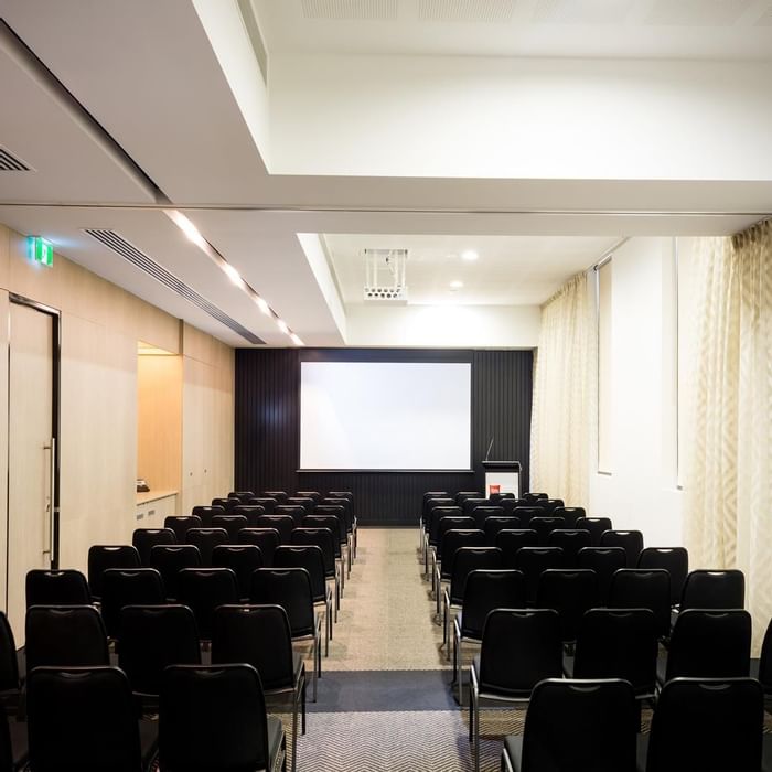 Theater-style set up facing a large screen in The Think Tank at Ibis Adelaide