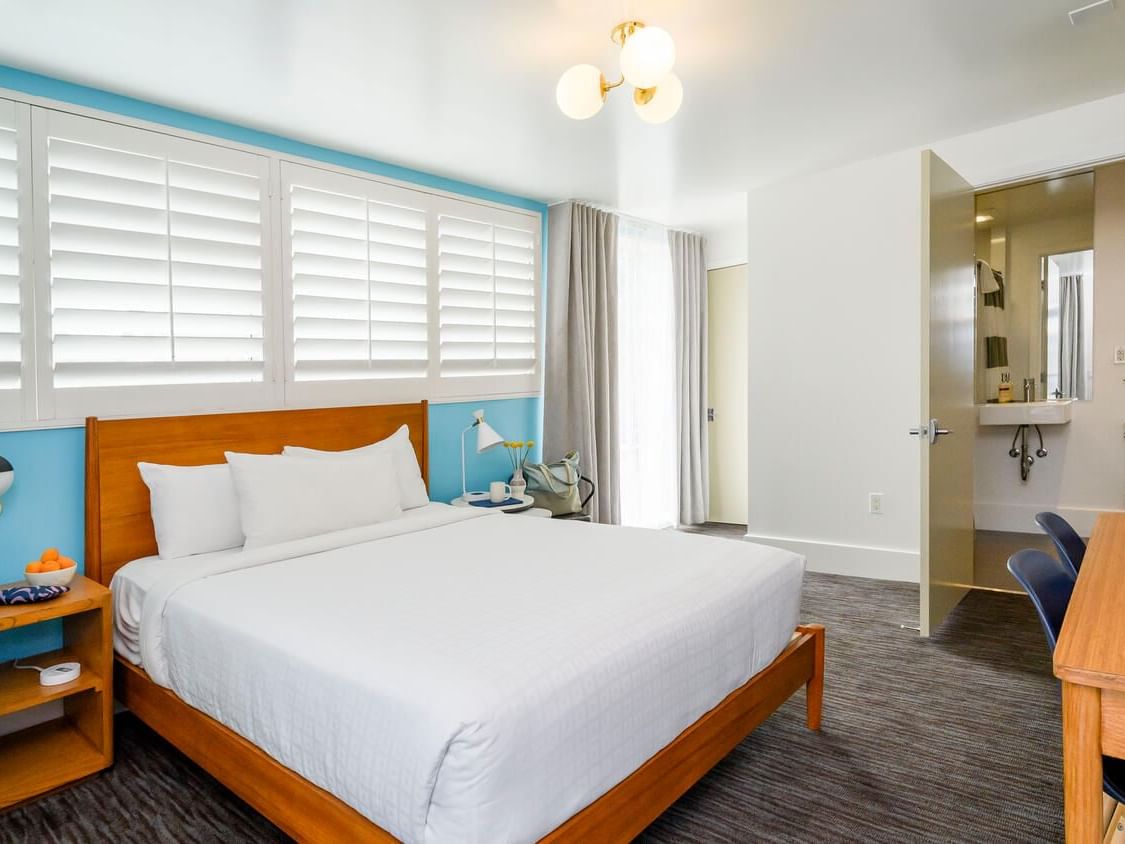 Bed and work area with carpeted floors in Queen with a View Room at Beck's Motor Lodge San Francisco California