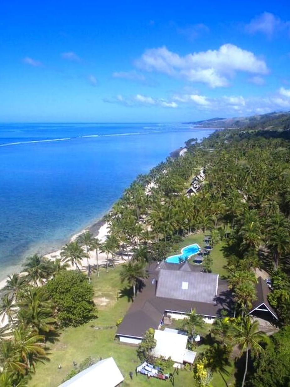 Aerial view of Tambua Sands Beach Resort by a sandy beach near Warwick Fiji Resort and Spa