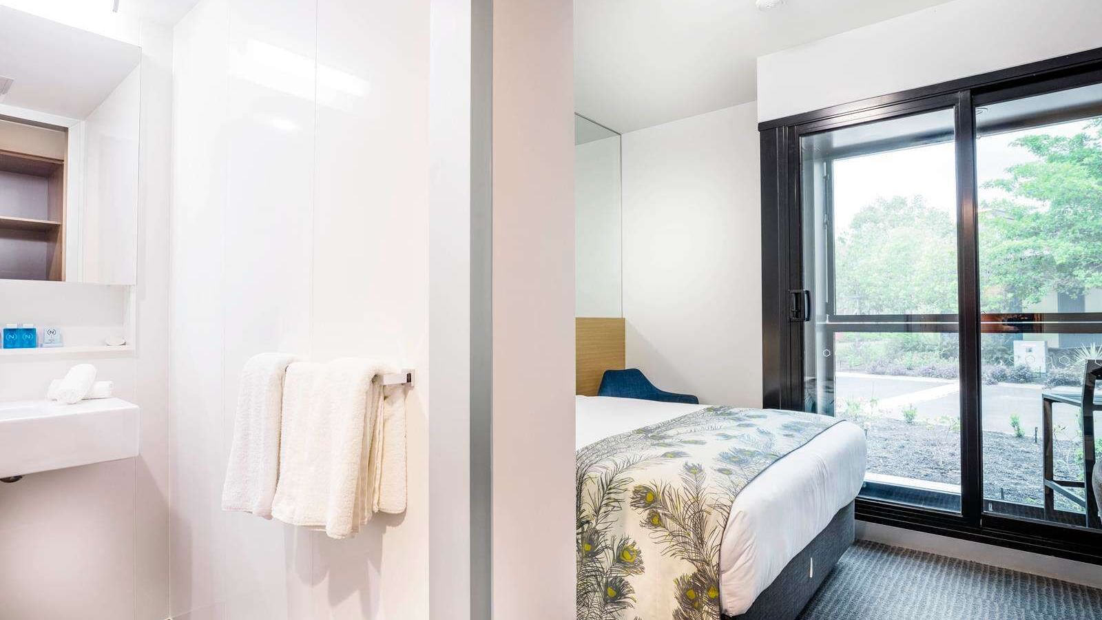 Bathroom & bedroom in Territory room at Darwin Airport Hotels