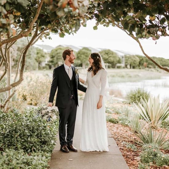 Wedding couple posing by the lake near Pullman Magenta Shores