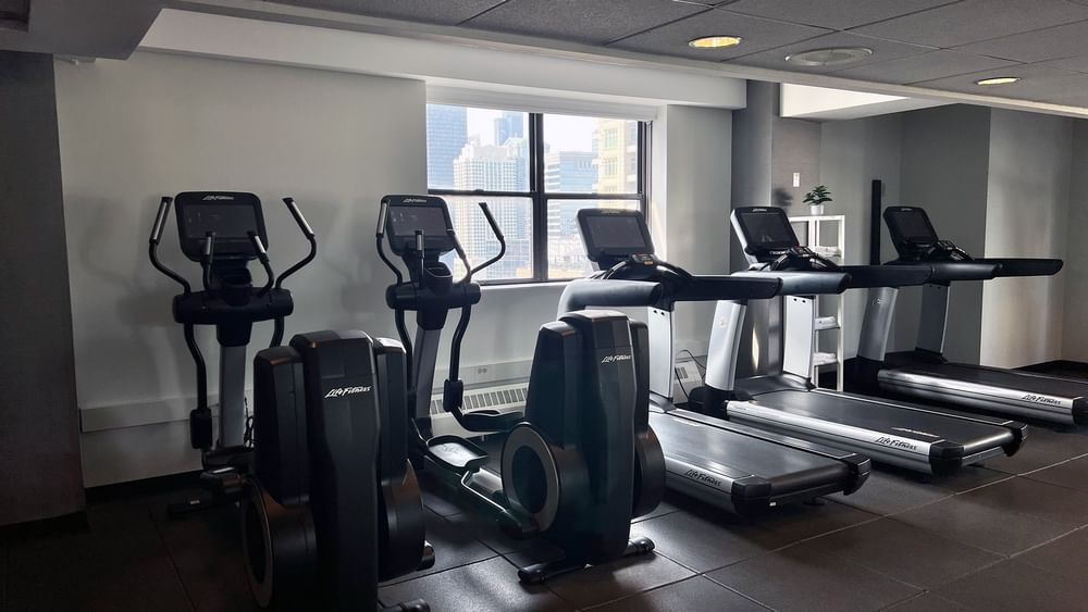 Modern fitness center with treadmills and exercise bikes at Warwick Allerton - Chicago in Chicago.
