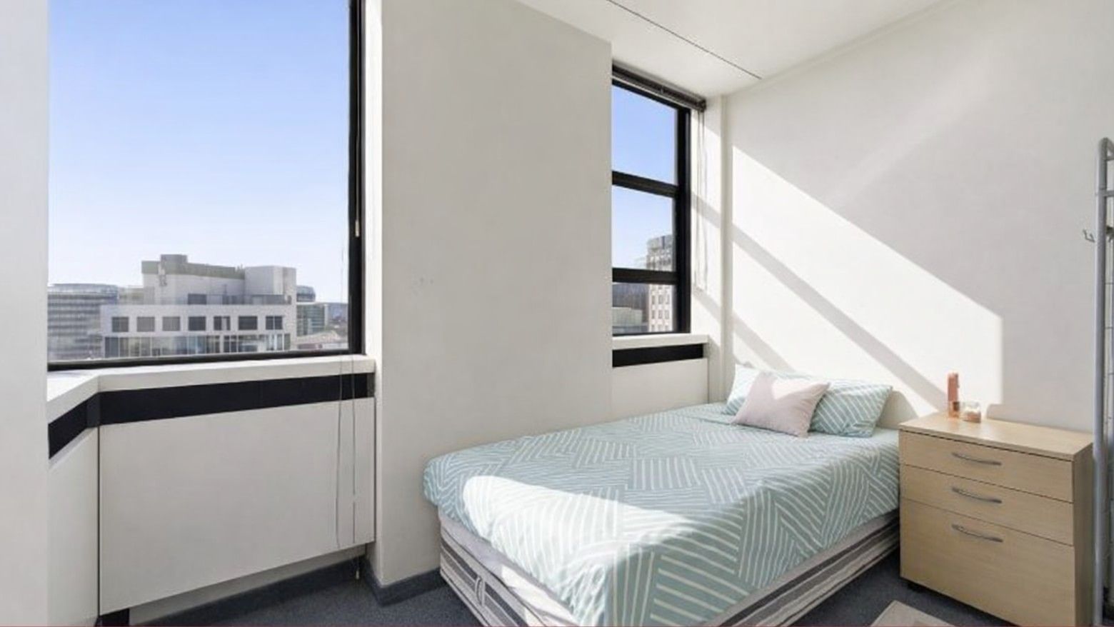 Modern room with a bed and a view of the city at UniLodge Stafford House.