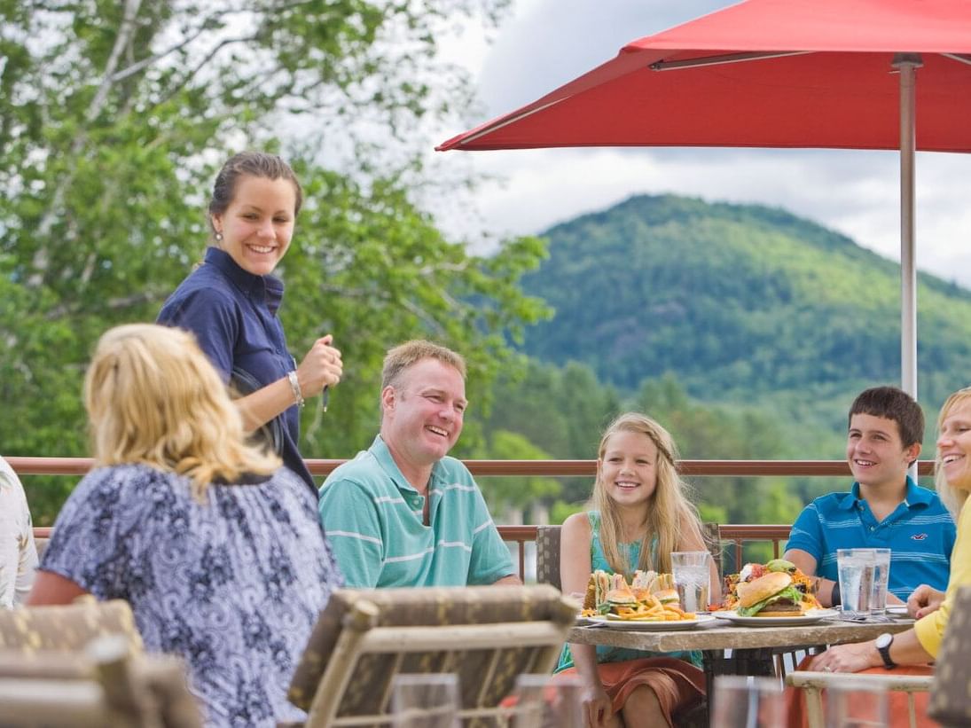 A family lunch on a restaurant deck by the lake at High Peaks Resort