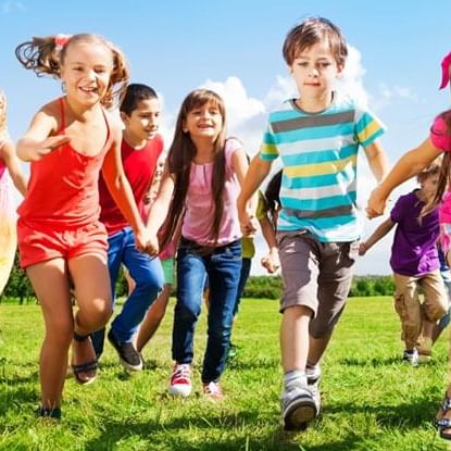 Kids running on the ground near Fairmont Hot Springs Resort