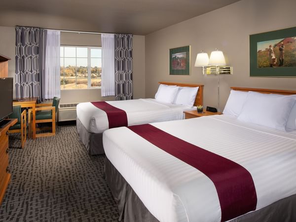 Two beds in stylish hotel room with window