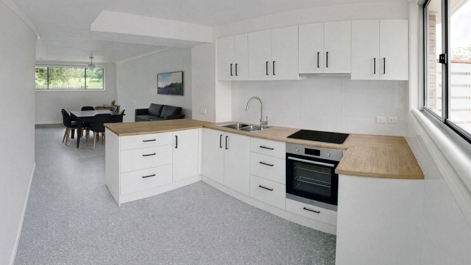 White kitchen and dining area with furniture and appliances at UniLodge SCU Lismore - Sirius.