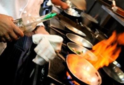 Chef making a dish in the La Scala near The Whittaker Inn