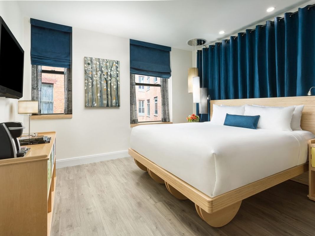 a bed facing a wall-mounted tv
