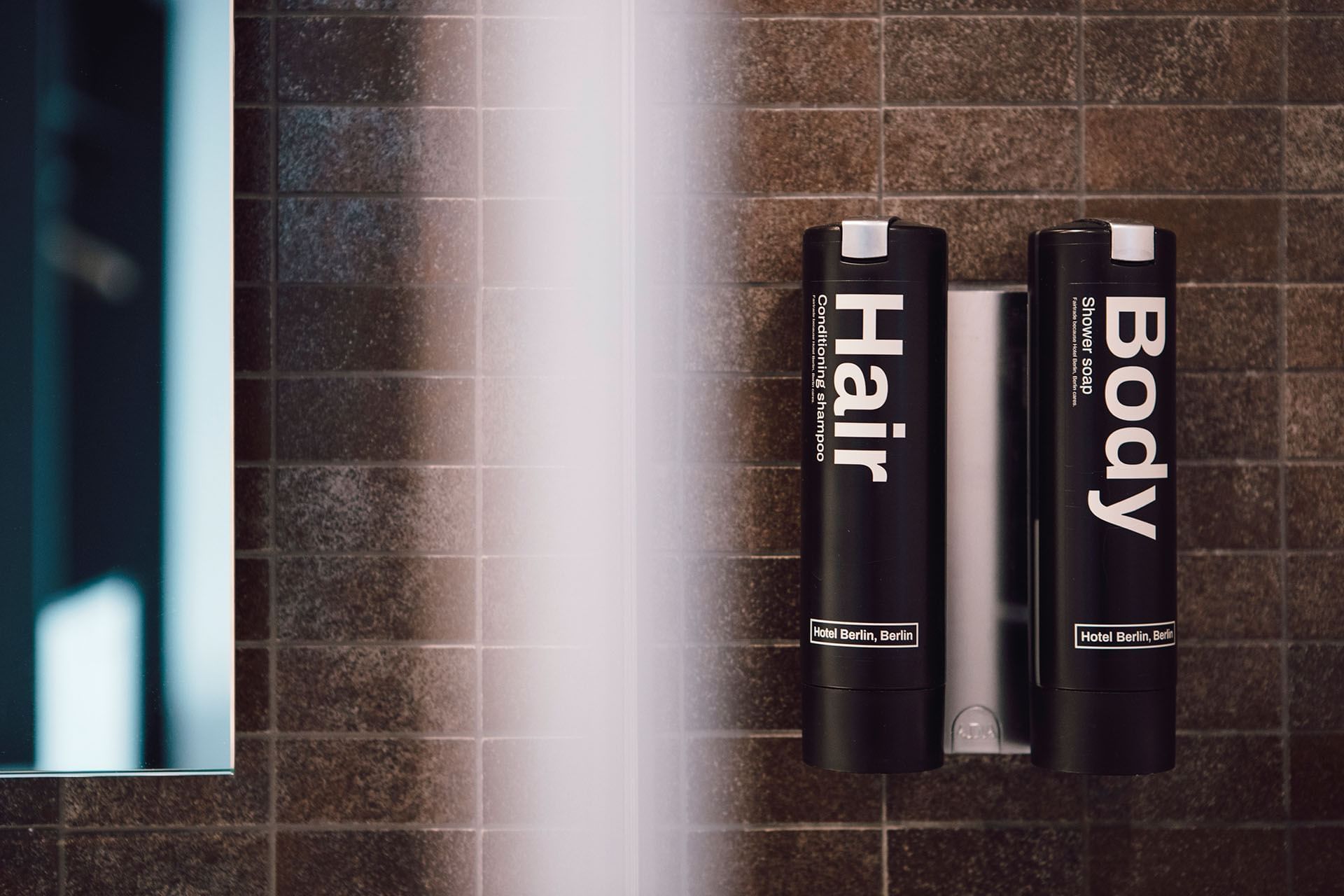 Hair and body amenities in a bathroom at Hotel Berlin Berlin