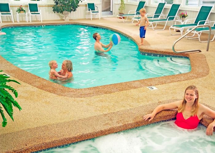 A family playing in the pool at Gorges Grant Hotel by Ogunquit Collection