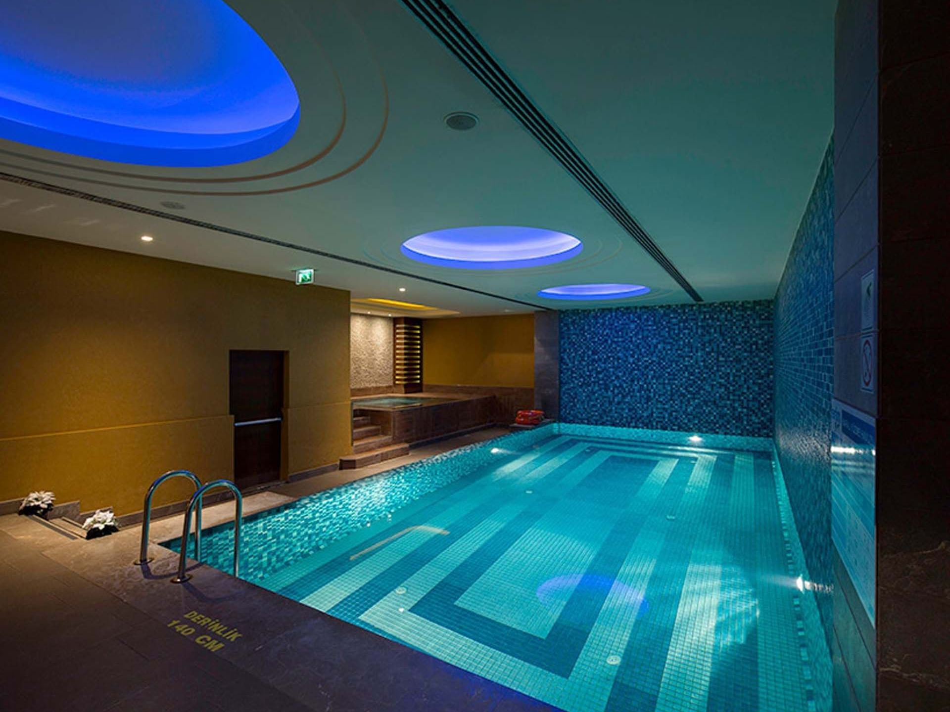 Indoor lit pool area in a spa at Titanic City Taksim