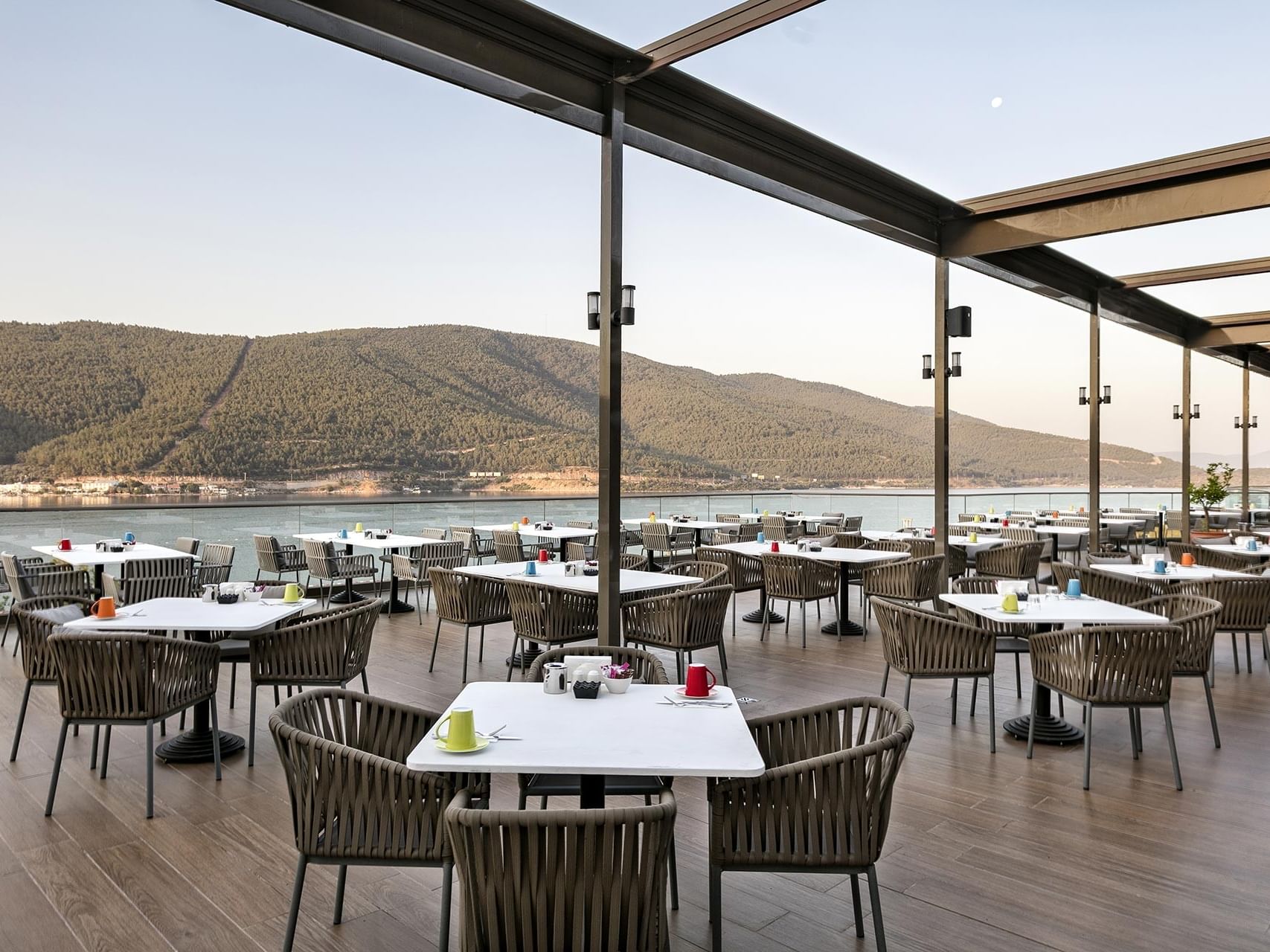 Open-air restaurant at Titanic Luxury Collection Bodrum with sea and mountain views.