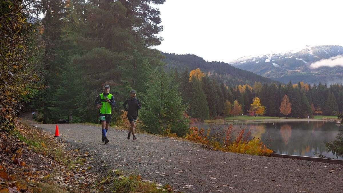 Adult couple jogging in Lost Lake Park near Blackcomb Springs Suites