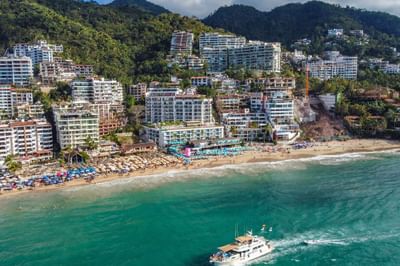 An aerial view of the beach and hillside buildings showing Almar Resort, a central Puerto Vallarta gay resort location