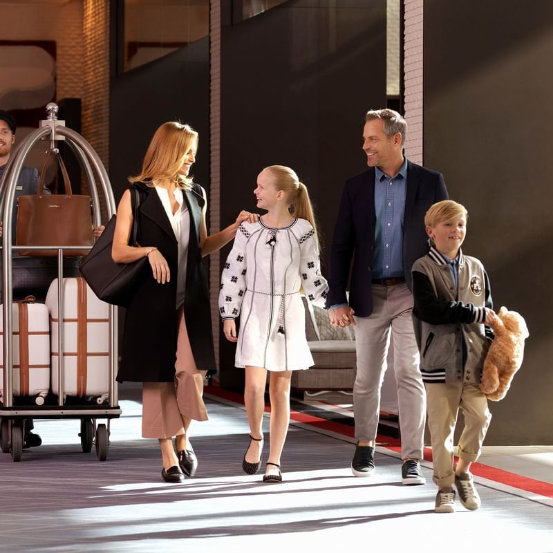 A family walking on a corridor at Crown Promenade Melbourne