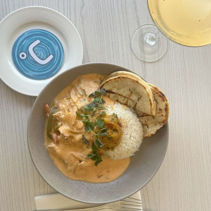 Creamy curry and rice served in a bowl at Celsius Restaurant & Bar by Mercure Hotel Townsville