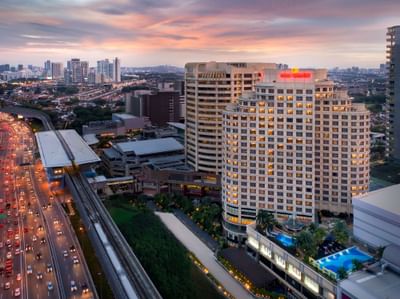 Aerial view of the city skyline with traffic moving along the highway near One World Hotel